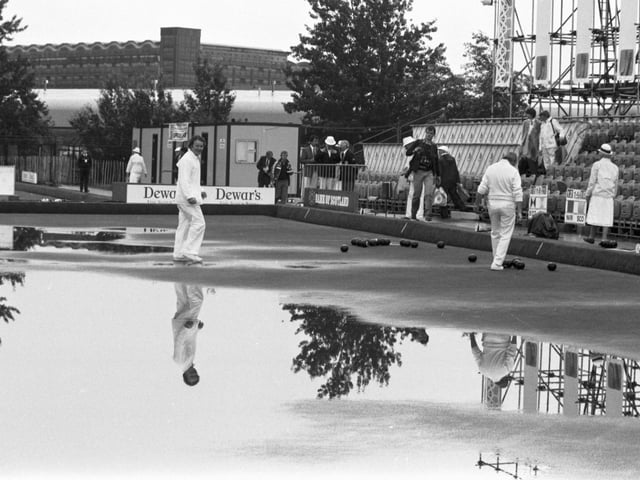 Rain doesn't stop play in the bowling events of the 1986 Commonwealth Games in Edinburgh. Despite the greens being flooded, play continued at Balgreen bowling club after heavy rain.