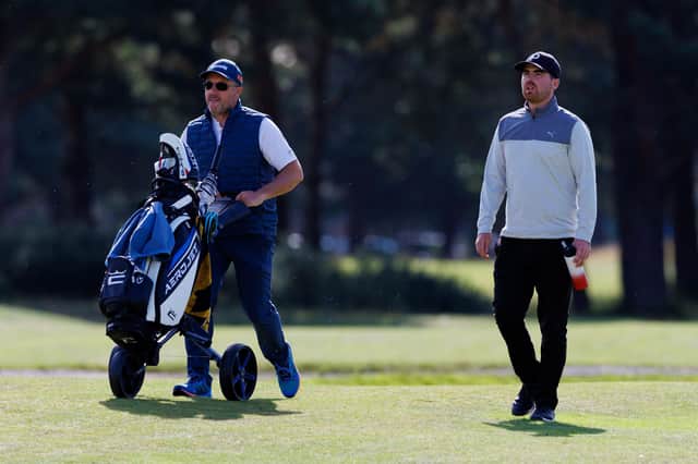 Jordan Brown makes his way down the 18th fairway with caddie Stuart Syme in the opening round of the Loch Lomond Whiskies Scottish PGA Championship at Scotscraig. Picture: Kenny Smith/Getty Images.