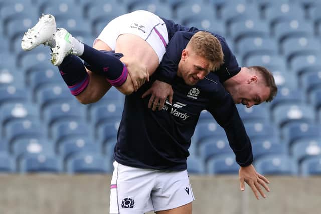 Stuart Hogg gets a lift at training from Scotland centre Chris Harris.  (Photo by Craig Williamson / SNS Group)