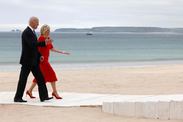 Joe Biden (L) and US First Lady Jill Biden arrive for the welcome prior to the start of the G7 summit in Carbis Bay, Cornwall . (Photo by Ludovic MARIN / AFP).