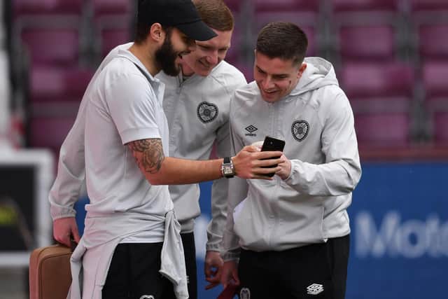 Kye Rowles, centre, and Cammy Devlin, right, are two of three Hearts players called up for the World Cup.