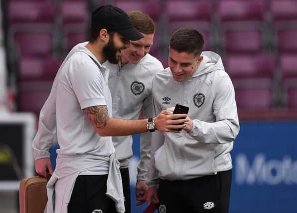 Kye Rowles, centre, and Cammy Devlin, right, are two of three Hearts players called up for the World Cup.