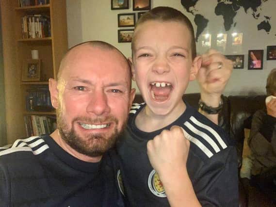 iain Meiklejohn and his son Aleks after the full-time whistle when Scotland beat Serbia on penalties to qualify for Euro 2020