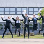 Students (from left) Claire McNab, Tegan Adair, Craig McGowan, Aaron Boyack, Niall Jowitt, Aaliyah McLaine and Mia Baillie at Auchmuty High School in Glenrothes, Fife, celebrate their results as high school pupils across Scotland find out their exam results. Picture date: Tuesday August 9, 2022.