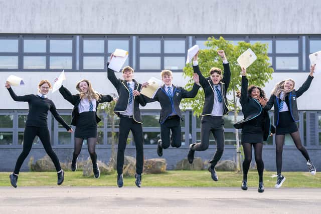 Students (from left) Claire McNab, Tegan Adair, Craig McGowan, Aaron Boyack, Niall Jowitt, Aaliyah McLaine and Mia Baillie at Auchmuty High School in Glenrothes, Fife, celebrate their results as high school pupils across Scotland find out their exam results. Picture date: Tuesday August 9, 2022.
