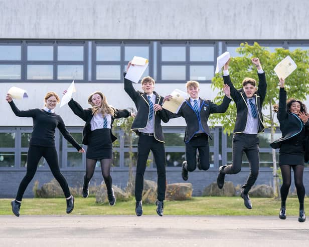 Students (from left) Claire McNab, Tegan Adair, Craig McGowan, Aaron Boyack, Niall Jowitt, Aaliyah McLaine and Mia Baillie at Auchmuty High School in Glenrothes, Fife, celebrate their results as high school pupils across Scotland find out their exam results. Picture date: Tuesday August 9, 2022.