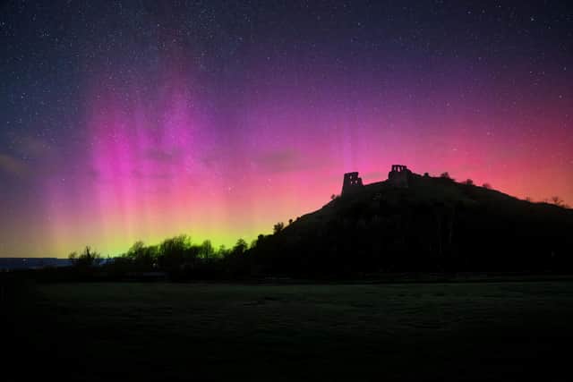 The northern lights are captured at 8:30pm at Dryslwyn Castle in Carmarthenshire, Wales on Sunday. Picture: Mathew Browne/SWNS