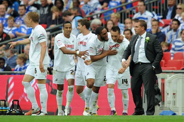 Stephen Dobbie celebrates with Swansea manager Brendan Rodgers having scored their third goal in a 4-2 win over Reading in the Championship Play-off final at Wembley. Photo by Dan Rowley/Shutterstock (7442650ad)