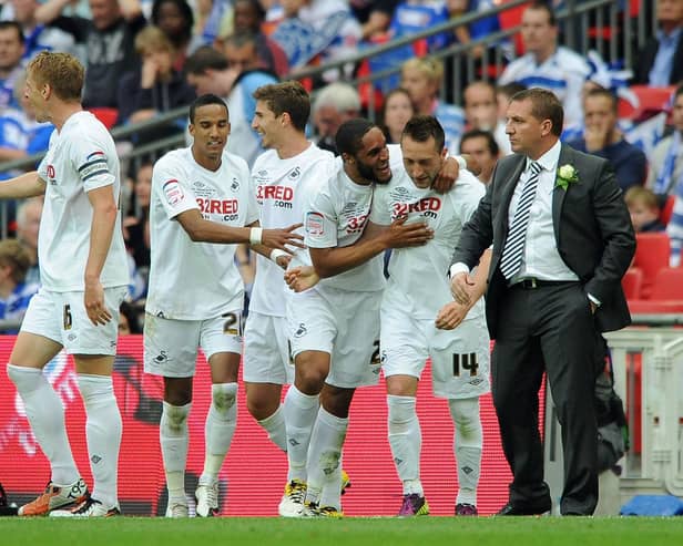 Stephen Dobbie celebrates with Swansea manager Brendan Rodgers having scored their third goal in a 4-2 win over Reading in the Championship Play-off final at Wembley. Photo by Dan Rowley/Shutterstock (7442650ad)