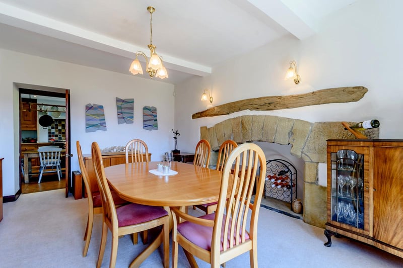 The dining room is positioned to the front of the house adjoining the kitchen. A key feature of the room is a stone inglenook style fireplace with a beamed lintel.