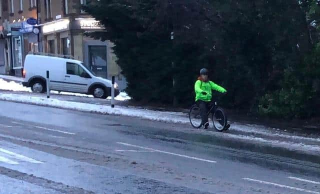 Cyclist struggles in the snow