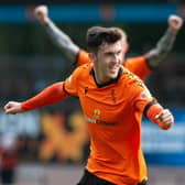Dundee United's Jamie McGrath celebrates after making it 1-0 against Livingston - although he later came off injured.