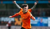 Dundee United's Jamie McGrath celebrates after making it 1-0 against Livingston - although he later came off injured.