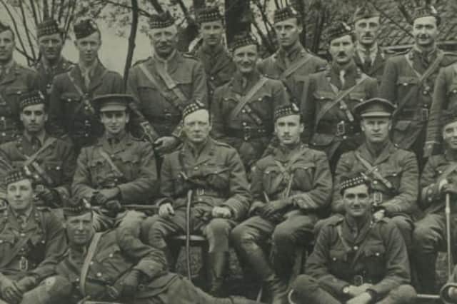 Lieutenant-Colonel Winston Churchill, seated centre wearing a Glengarry bonnet, and Andrew Dewar Gibb, also in a Glengarry, pose for a picture with other officers during the First World War