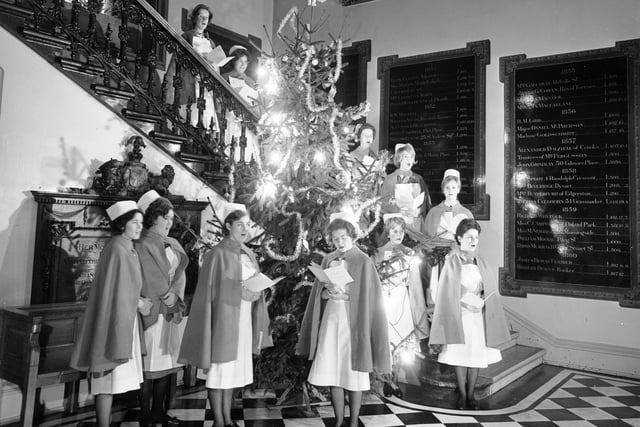 Nurses singing Christmas carols round the Christmas tree at the Edinburgh Royal Infirmary, 1960s