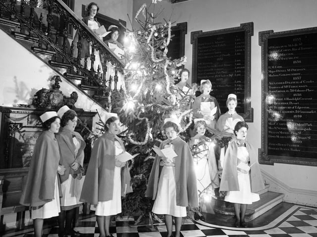 Nurses singing Christmas carols round the Christmas tree at the Edinburgh Royal Infirmary, 1960s