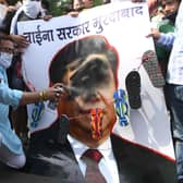 Activists of Bharatiya Janata Party (BJP) spray black paint on a poster depicting Chinese President Xi Jinping during a protest in Amritsar after an India-China border clash that left 20 troops dead (Picture: Narinder Nanu/AFP via Getty Images)