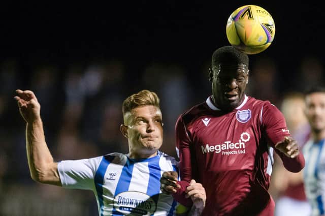 Arbroath's Joel Nouble and Kilmarnock's Euan Murray challenge for the ball at Gayfield.