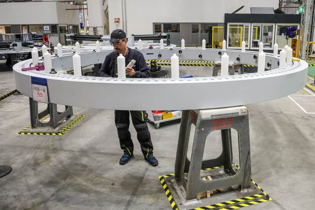 An employee works on a wind turbine blade bearing at the Siemens Gamesa factory – in Germany (Picture: Focke Strangmann/AFP via Getty Images)