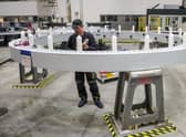 An employee works on a wind turbine blade bearing at the Siemens Gamesa factory – in Germany (Picture: Focke Strangmann/AFP via Getty Images)