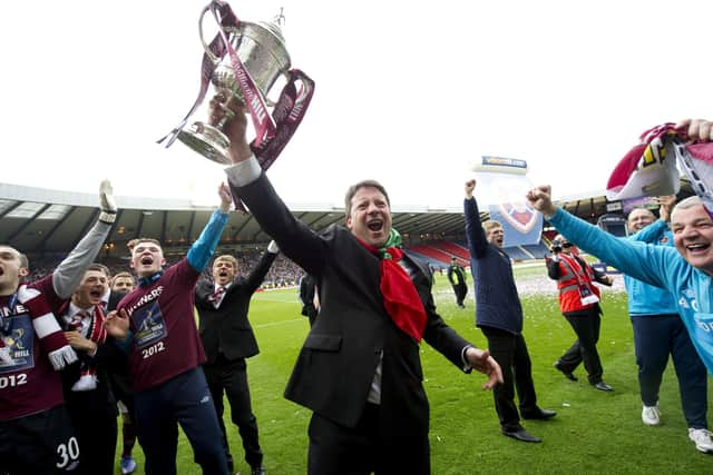 Hearts manager Paulo Sergio lifts the Scottish Cup after a 5-1 win over Hibs in 2012.