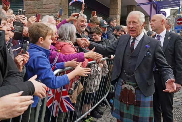 King Charles III greets members of the public as he arrives at an official council meeting at the City Chambers in Dunfermline