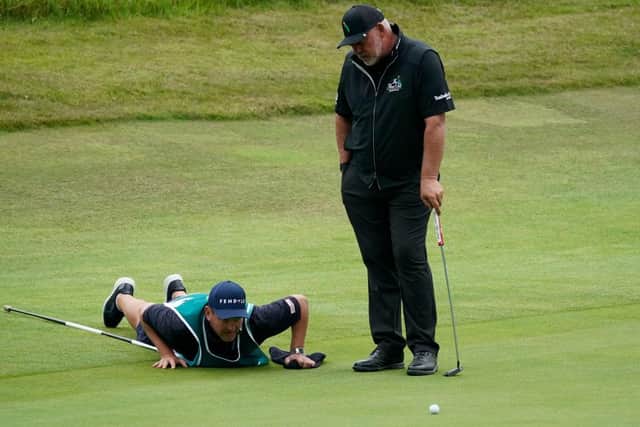 Darren Clarke looks on as caddie Jamie Lane gets down to business to line up a putt on the King's Course at Gleneagles. Picture: Phil Inglis/Getty Images.