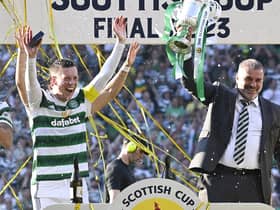 Celtic manager Ange Posetcoglou lifts the Scottish Cup trophy alongside captain Callum McGregor. (Photo by Rob Casey / SNS Group)