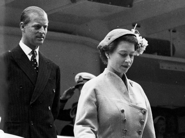 Queen Elizabeth II and the Duke of Edinburgh walk down the gangway of the Royal Yacht Britannia at Aberdeen in August 1955.