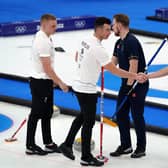 Great Britain's Hammy McMillan and Bobby Lammie shake hands with Sweden team after losing the Men's Gold Medal game.