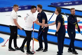 Great Britain's Hammy McMillan and Bobby Lammie shake hands with Sweden team after losing the Men's Gold Medal game.