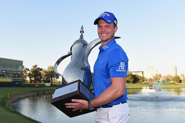 Danny Willett poses with the trophy after his victory in the Omega Dubai Desert Classic at the Emirates Golf Club in 2016 - the same year he became a major winner in the Masters. Picture: Ross Kinnaird/Getty Images.