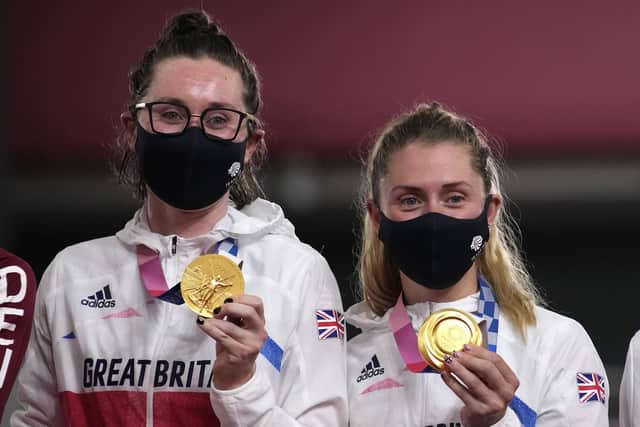 Katie Archibald, left, and Laura Kenny show off their gold medals following their victory in the first ever Olympic women's Madison. Picture: Christophe Ena/AP