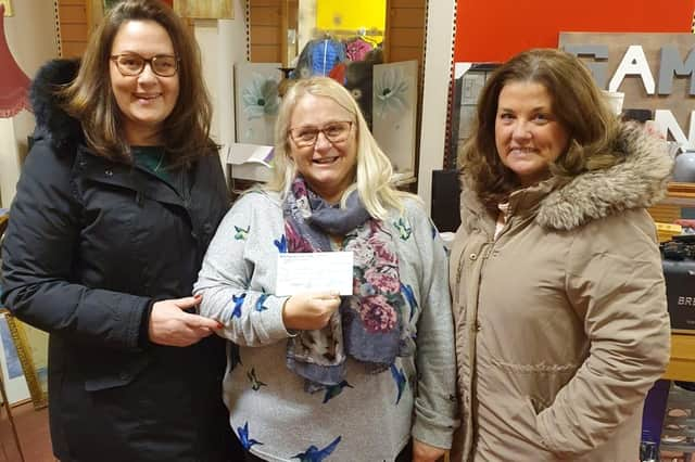 Shona Watson of Buchan Giving Tree SCIO receives the cheque from Sheena Gordon and Alison Morgan of Apex.