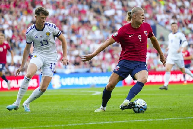 Scotland defender Jack Hendry shadows Norway striker Erling Braut Haaland. (Photo by FREDRIK VARFJELL/NTB/AFP via Getty Images)