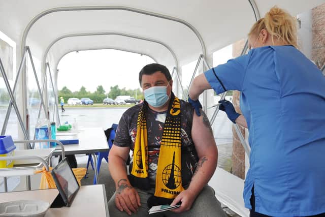 Falkirk fan Collin Reid, 46, from Grangemouth, receives his second Covid vaccine from staff nurse Heather Dowell in the pop-up tunnel at The Falkirk Stadium (Picture: Michael Gillen)