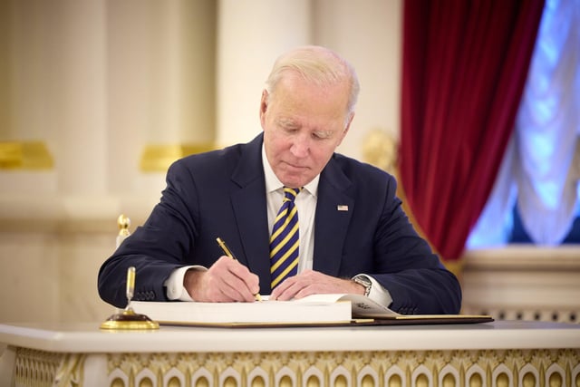 Handout photo issued by the Office of the US President Joe Biden signing a visitors book as he made an unannounced visit to Kyiv, Ukraine, in a gesture of solidarity days before the one-year anniversary of Russia's invasion of the country.