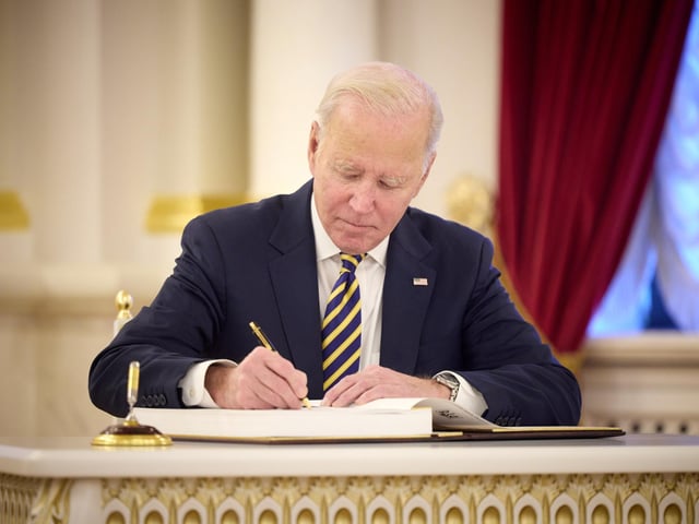 Handout photo issued by the Office of the US President Joe Biden signing a visitors book as he made an unannounced visit to Kyiv, Ukraine, in a gesture of solidarity days before the one-year anniversary of Russia's invasion of the country.
