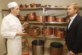 Australian chef and restaurateur Bill Granger is shown around Buckingham Palace's kitchens in 2011.