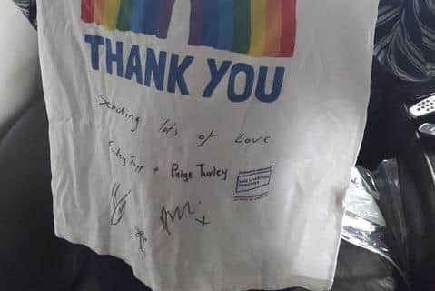 The signed T-shirt donated by Paige Turley and Finn Tapp from Love Island.