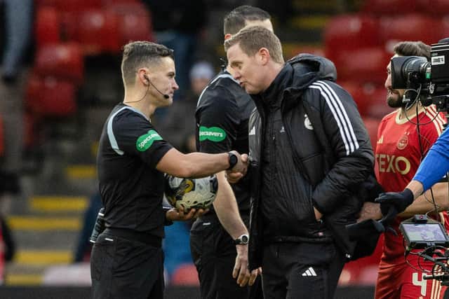 Aberdeen manager Barry Robson speaks to referee Nick Walsh at full time after the 1-1 draw with Rangers at Pittodrie. (Photo by Craig Williamson / SNS Group)