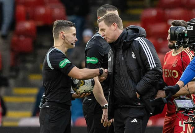Aberdeen manager Barry Robson speaks to referee Nick Walsh at full time after the 1-1 draw with Rangers at Pittodrie. (Photo by Craig Williamson / SNS Group)