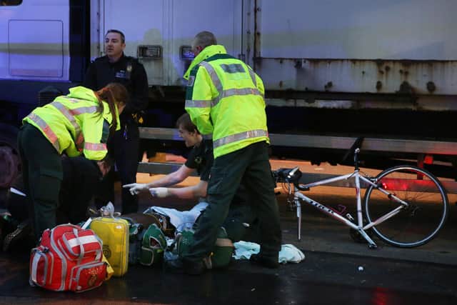 A cyclist receives medical treatment after being involved in a collision with a lorry in London (Picture: Peter Macdiarmid/Getty Images)