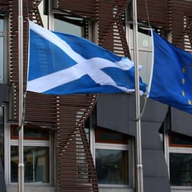 A Saltire and a European Union flag fly outside the Scottish Parliament in Edinburgh
