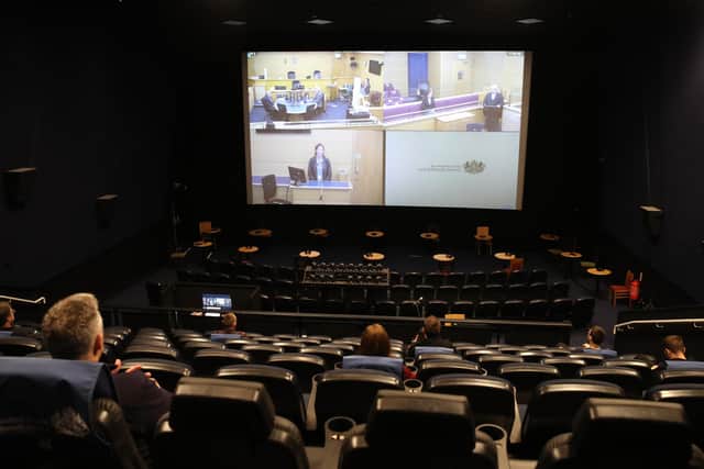 A mock trial is shown on a screen as people sit in marked seats where a jury would sit in screen number three at an Odeon multiplex in Edinburgh
