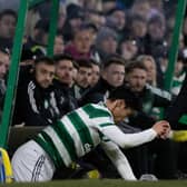 Livingston manager David Martindale helps Celtic midfielder Reo Hatate up after a James Penrice challenge. (Photo by Craig Williamson / SNS Group)