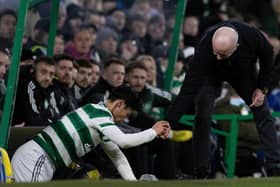 Livingston manager David Martindale helps Celtic midfielder Reo Hatate up after a James Penrice challenge. (Photo by Craig Williamson / SNS Group)