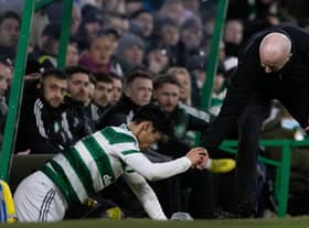 Livingston manager David Martindale helps Celtic midfielder Reo Hatate up after a James Penrice challenge. (Photo by Craig Williamson / SNS Group)