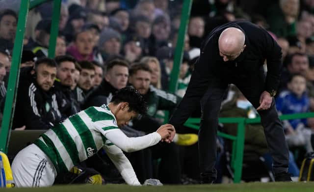 Livingston manager David Martindale helps Celtic midfielder Reo Hatate up after a James Penrice challenge. (Photo by Craig Williamson / SNS Group)