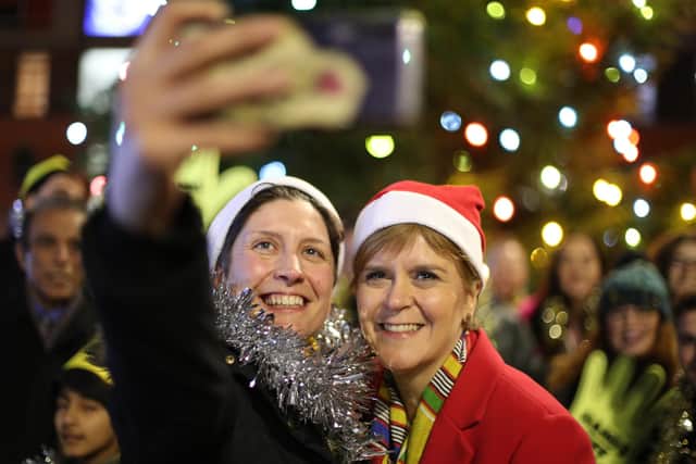 SNP leader Nicola Sturgeon with Alison Thewliss having a selfie taken during a visit to Gorbals Parish Church
